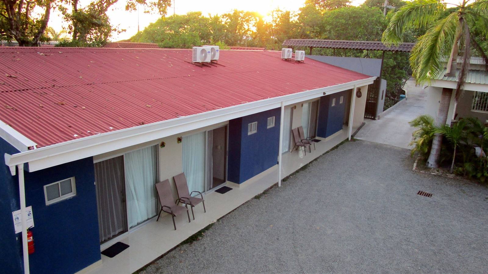 Hotel Sueño Tranquilo: two-story building with red roof and air conditioners